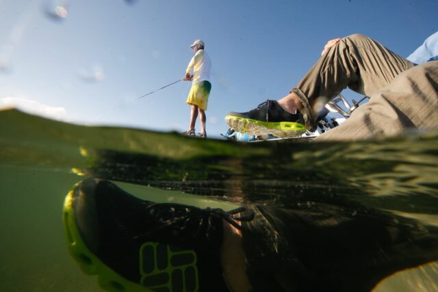 Ronell Smith fishing from a flats boat at Islamorado with Columbia Apparel guide